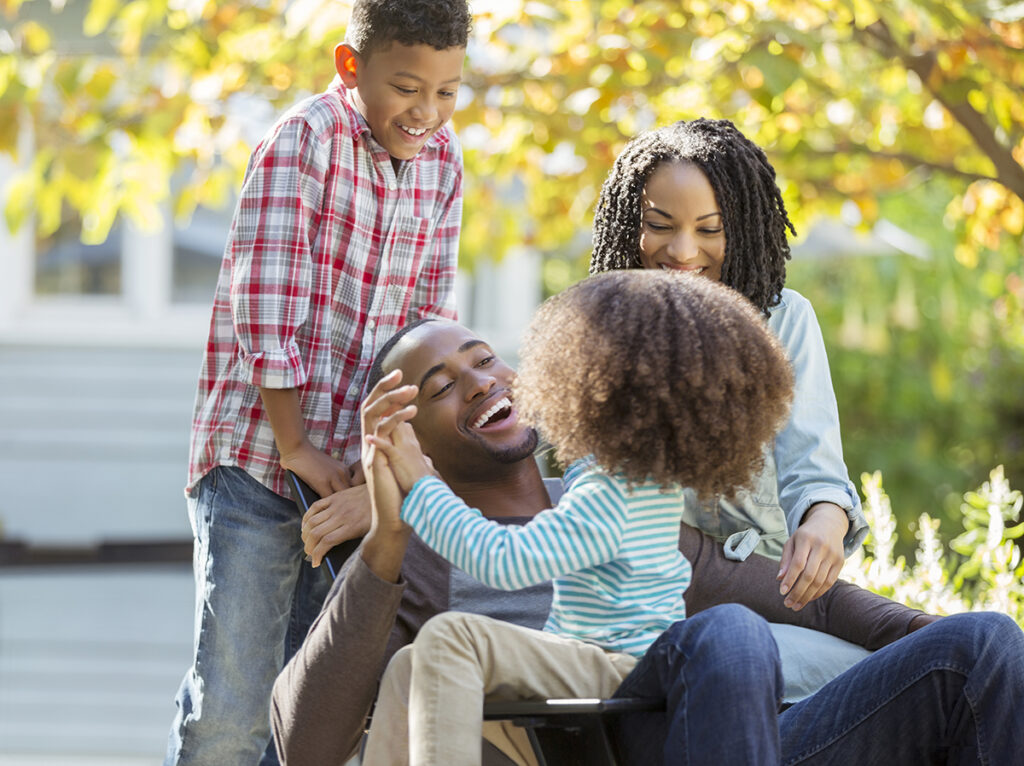 Happy family laughing outdoors